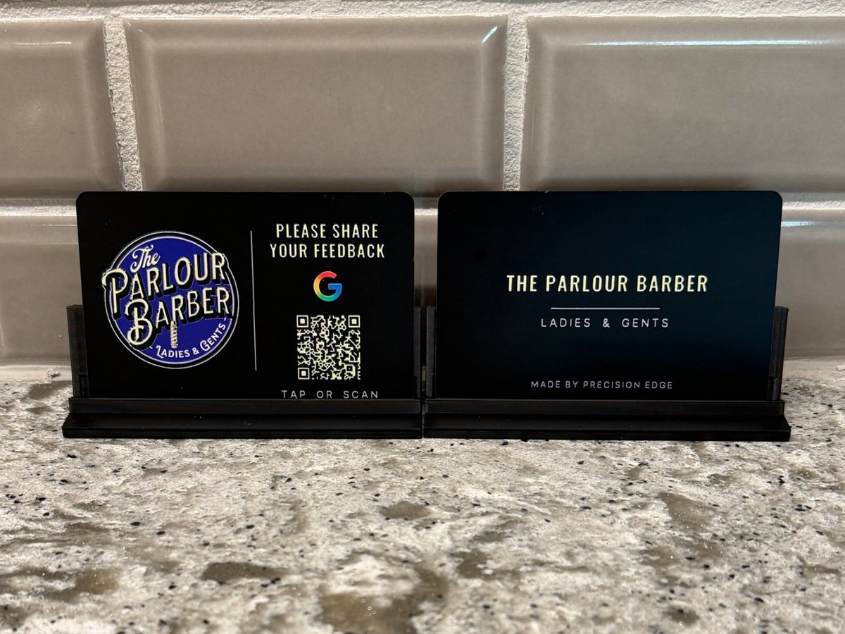 Tap-to-review Google card for The Parlour Barber, full-color UV printed, front and back shown in black counter stands