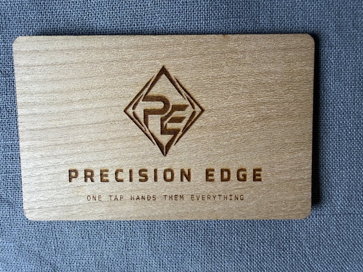 Precision Edge card engraved into maple, logo and tagline burned into the grain